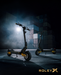 Two black and yellow ROLEYX electric scooters displayed in a moody, dark industrial setting with dramatic lighting and a stack of shipping containers in the background.