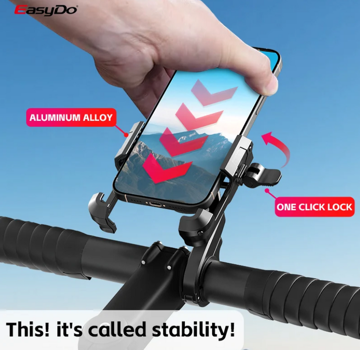 A hand holds a smartphone in a black and silver EasyDo bike handlebar mount against a blue sky background. The image includes red callout labels reading 'ALUMINUM ALLOY' and 'ONE CLICK LOCK', plus a large text overlay at the bottom saying 'This! it's called stability!'.