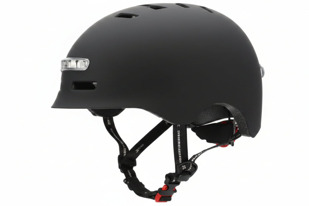 A black skate helmet with black adjustable chin straps and a small white logo on the side, shown against a plain white background.