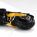 Close-up of a scooter's suspension system with a black tire and gold suspension on a white background